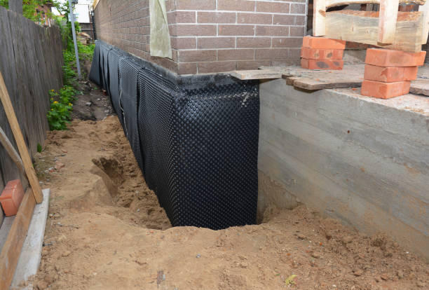 SJ Waterproofing Pros technician performing targeted Wet Basement Repair assessment in Kettlersville, OH